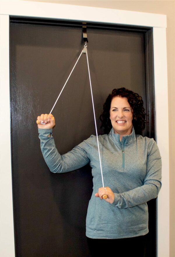 A woman standing in front of a door holding a Shoulder Kit Pro.